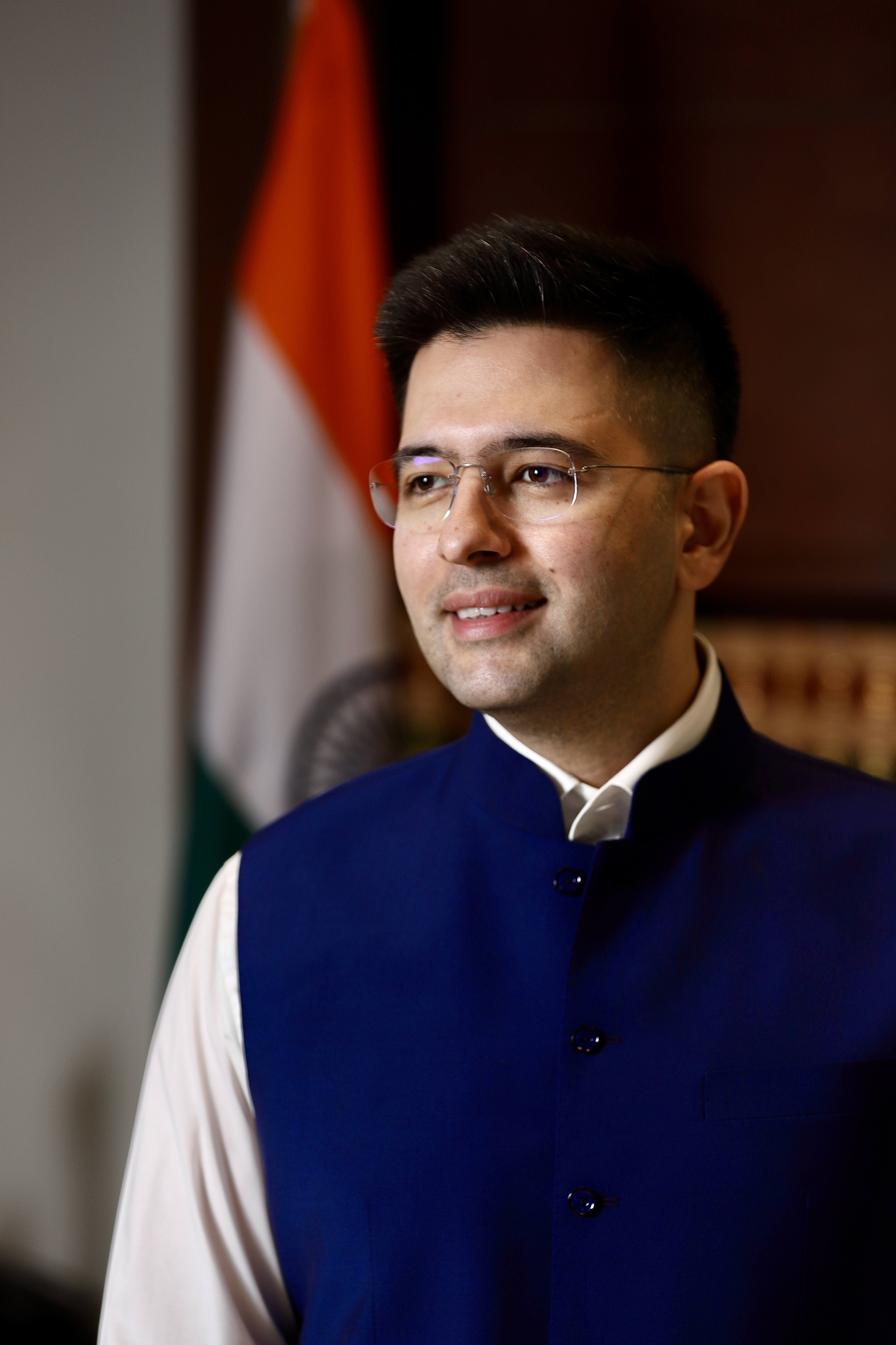 Raghav Chadha in traditional blue attire with Indian flag